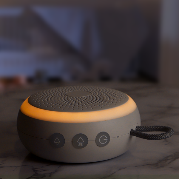 Portable speaker with adjustable amber night light on a marble surface